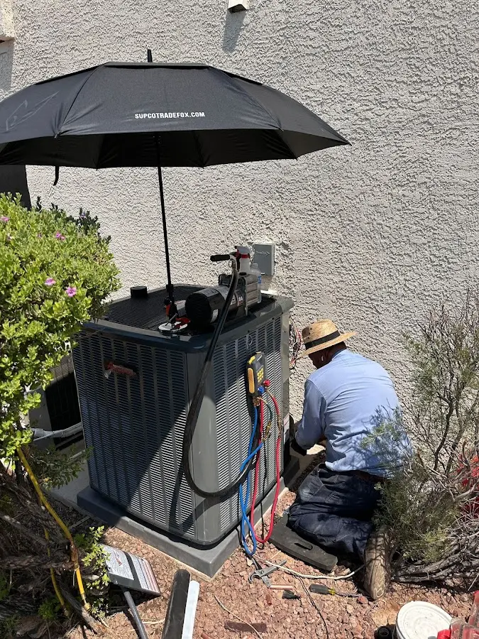 HVAC technician performing outdoor AC maintenance in Puyallup